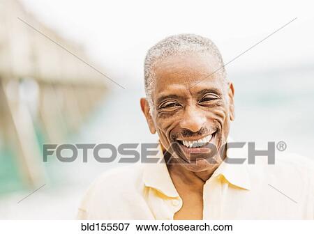 Older mixed race man smiling on beach View Large Photo Image Stock Photo - Older mixed race man smiling on beach. Fotosearch