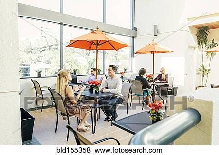 Stock Photo - People having lunch in cafe. Fotosearch