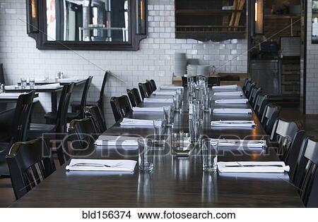 Picture - Place settings at table in empty restaurant. Fotosearch