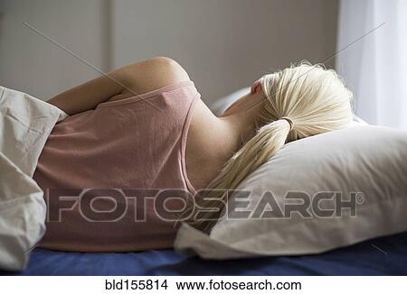 Rear view of woman sleeping in bed View Large Photo Image Picture - Rear view of woman sleeping in bed. Fotosearch