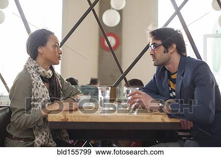 Stock Photo - Serious couple talking in cafe. Fotosearch