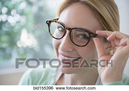 Smiling Caucasian woman wearing eyeglasses View Large Photo Image Stock Photograph - Smiling Caucasian woman wearing eyeglasses. Fotosearch