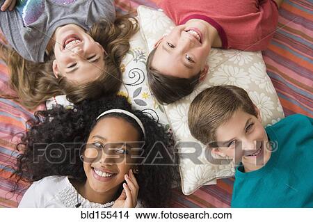 Picture - Smiling children laying in circle. Fotosearch