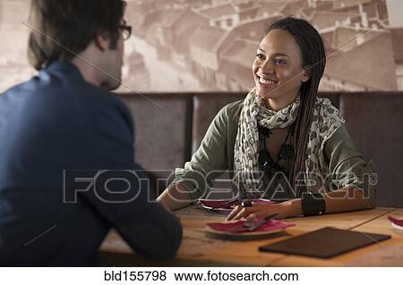 Smiling couple talking in cafe View Large Photo Image Stock Photo - Smiling couple talking in cafe. Fotosearch