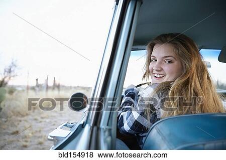 Smiling woman driving vintage car View Large Photo Image Stock Photo - Smiling woman driving vintage car. Fotosearch