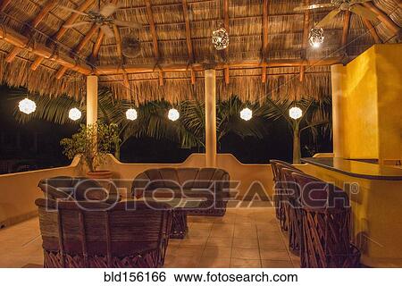 Sofas and chairs with bar on outdoor patio at night View Large Photo Image Stock Photograph - Sofas and chairs with bar on outdoor patio at night. Fotosearch