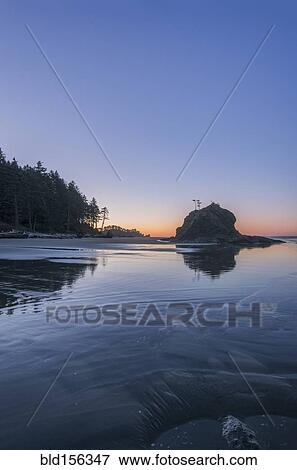 Sunrise horizon behind rock formations on beach View Large Photo Image Stock Photo - Sunrise horizon behind rock formations on beach. Fotosearch