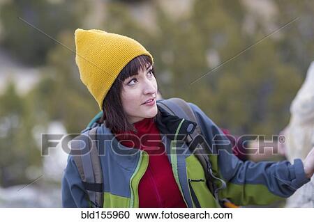 Stock Image - Woman admiring rock formations. Fotosearch