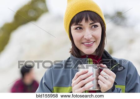 Stock Photo - Woman drinking coffee outdoors. Fotosearch