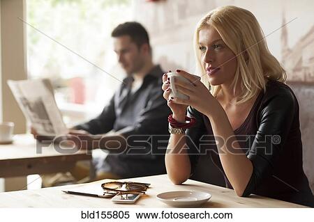 Stock Photography - Woman drinking cup of coffee in cafe. Fotosearch