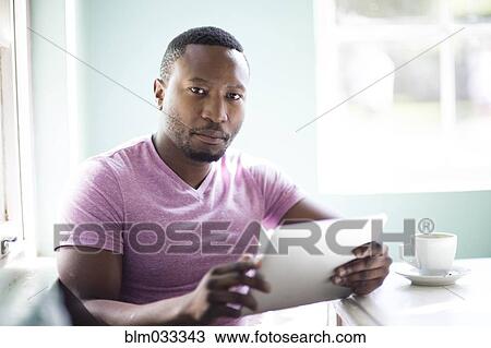 Black man using digital tablet View Large Photo Image Stock Image - Black man using digital tablet. Fotosearch