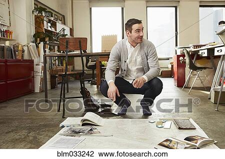 Caucasian businessman working on floor in office View Large Photo Image Stock Image - Caucasian businessman working on floor in office. Fotosearch