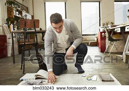 Caucasian businessman working on floor in office View Large Photo Image Stock Image - Caucasian businessman working on floor in office. Fotosearch