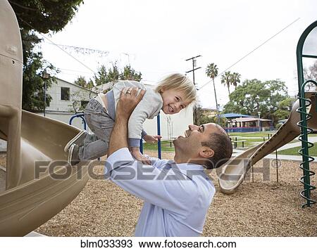 Hispanic father and son playing on playground View Large Photo Image Stock Image - Hispanic father and son playing on playground. Fotosearch