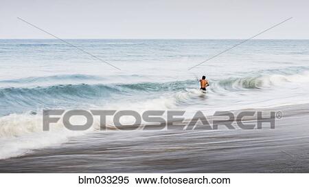 Stock Photography - Man swimming in waves. Fotosearch
