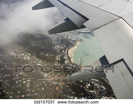 Aerial view of airplane wing flying over Wellington cityscape, Wellington, New Zealand View Large Photo Image Stock Image - Aerial view of airplane wing flying over Wellington cityscape, Wellington, New Zealand. Fotosearch