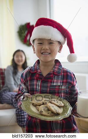Asian boy holding plate of cookies for Santa View Large Photo Image Stock Image - Asian boy holding plate of cookies for Santa. Fotosearch