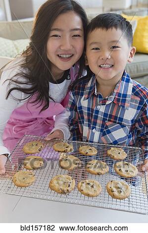 Asian brother and sister baking cookies View Large Photo Image Stock Image - Asian brother and sister baking cookies. Fotosearch