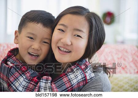 Asian brother and sister hugging View Large Photo Image Stock Photo - Asian brother and sister hugging. Fotosearch