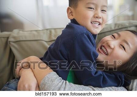 Asian brother and sister playing on sofa View Large Photo Image Stock Image - Asian brother and sister playing on sofa. Fotosearch