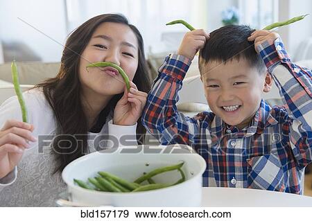 Asian brother and sister playing with vegetables View Large Photo Image Stock Photo - Asian brother and sister playing with vegetables. Fotosearch