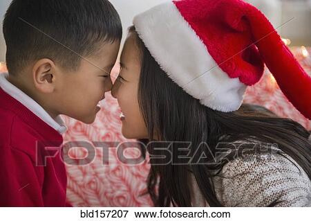 Asian brother and sister rubbing noses at Christmas View Large Photo Image Stock Photo - Asian brother and sister rubbing noses at Christmas. Fotosearch