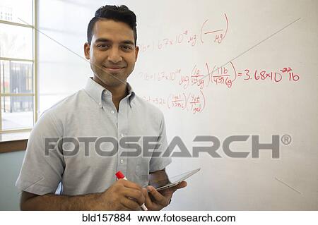 Picture - Asian businessman using digital tablet at whiteboard. Fotosearch