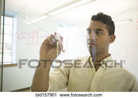 Asian businessman writing on glass window in office View Large Photo Image Stock Image - Asian businessman writing on glass window in office. Fotosearch