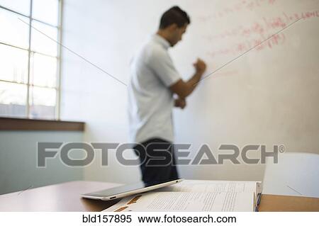 Stock Photography - Asian businessman writing on whiteboard. Fotosearch