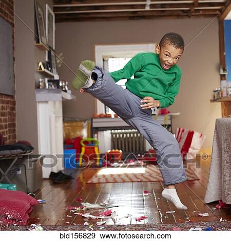 Black boy doing karate kick in living room View Large Photo Image Stock Photo - Black boy doing karate kick in living room. Fotosearch