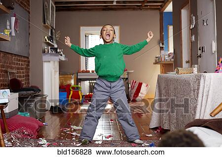 Stock Photo - Black boy shouting in living room. Fotosearch