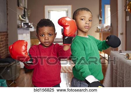 Black boys posing with boxing gloves in living room View Large Photo Image Stock Photography - Black boys posing with boxing gloves in living room. Fotosearch