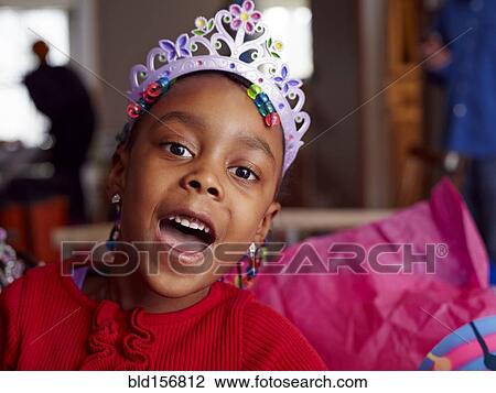 Stock Image - Black girl wearing tiara at party. Fotosearch