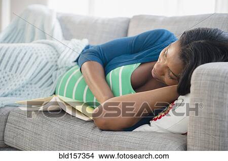 Black pregnant woman napping on sofa View Large Photo Image Picture - Black pregnant woman napping on sofa. Fotosearch