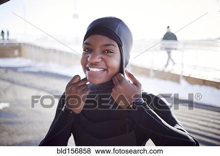 Black teenage girl putting on wetsuit swimming cap View Large Photo Image Stock Photo - Black teenage girl putting on wetsuit swimming cap. Fotosearch