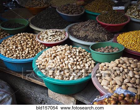 Picture - Bowls of dried grains and nuts for sale in market. Fotosearch