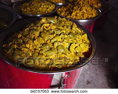 Stock Image - Bowls of fresh pickled mango for sale in market. Fotosearch