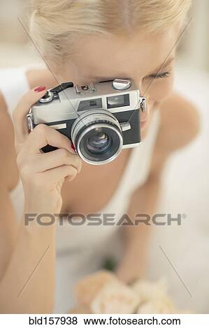Stock Photo - Bride photographing with vintage camera. Fotosearch