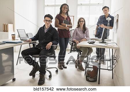 Stock Image - Business people smiling in office. Fotosearch