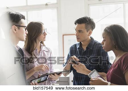 Business people working together in office with technology View Large Photo Image Stock Photo - Business people working together in office with technology. Fotosearch