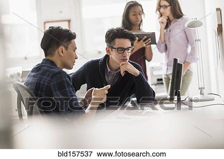 Businessmen working together in office View Large Photo Image Stock Photo - Businessmen working together in office. Fotosearch