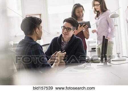 Businessmen working together in office View Large Photo Image Stock Photo - Businessmen working together in office. Fotosearch