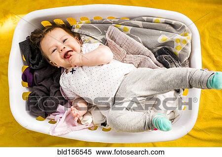 Caucasian baby girl laying in laundry basket View Large Photo Image Stock Photography - Caucasian baby girl laying in laundry basket. Fotosearch