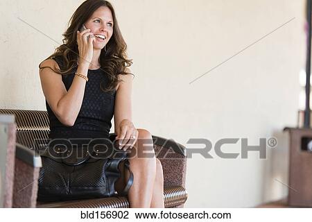 Stock Image - Caucasian businesswoman talking on cell phone. Fotosearch