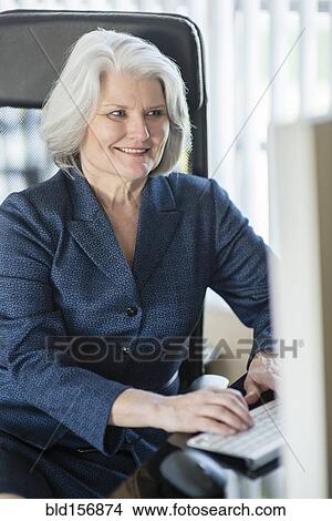 Caucasian businesswoman working at computer View Large Photo Image Picture - Caucasian businesswoman working at computer. Fotosearch