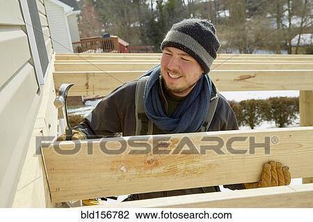Caucasian carpenter building house extension in winter View Large Photo Image Stock Image - Caucasian carpenter building house extension in winter. Fotosearch