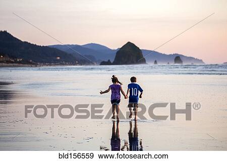 Caucasian children walking on beach View Large Photo Image Stock Photo - Caucasian children walking on beach. Fotosearch