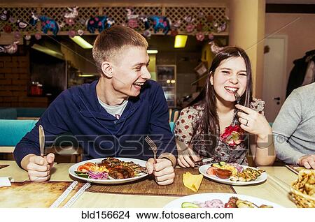 Picture - Caucasian couple laughing in restaurant. Fotosearch
