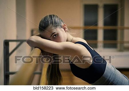 Caucasian dancer leaning on barre in studio View Large Photo Image Stock Image - Caucasian dancer leaning on barre in studio. Fotosearch