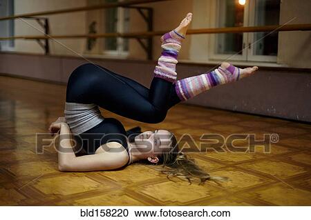 Caucasian dancer stretching back on studio floor View Large Photo Image Stock Image - Caucasian dancer stretching back on studio floor. Fotosearch